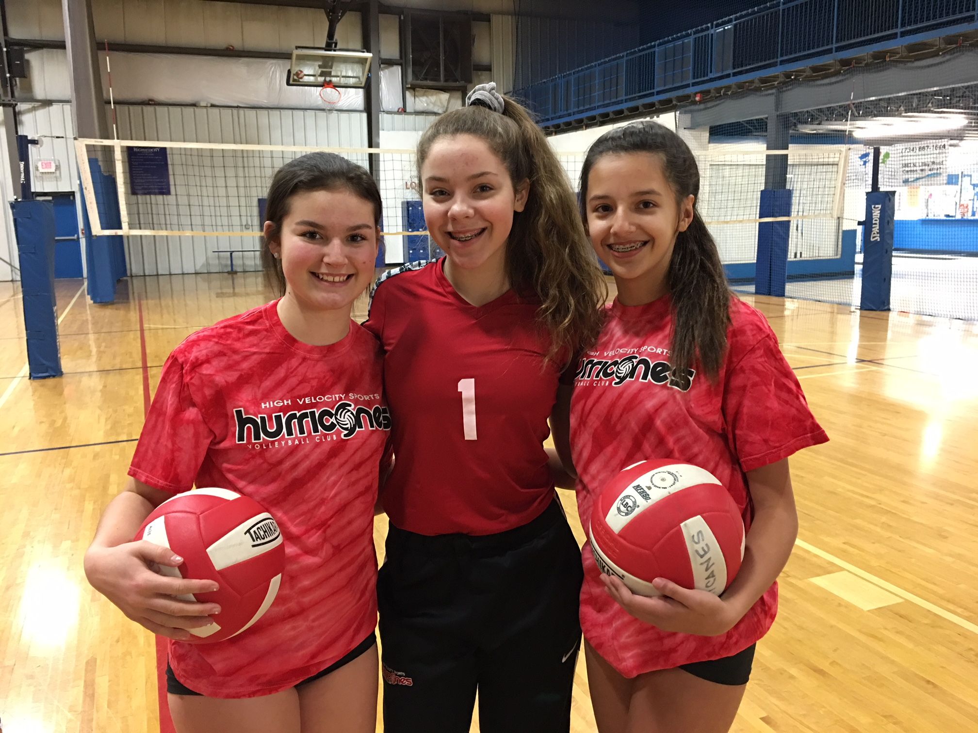 Players taking a break from volleyball serving drills at High Velocity Sports