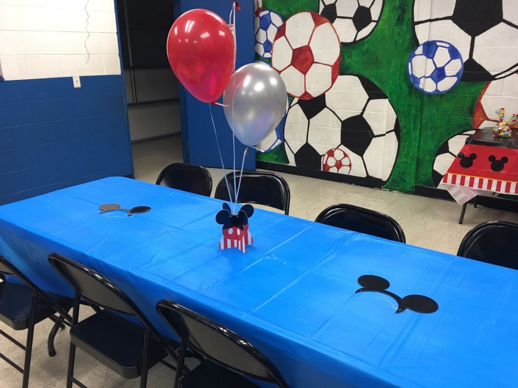 Table decorations and balloons for a Mickey themed birthday